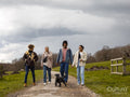 Group of young friends with dog in countryside
