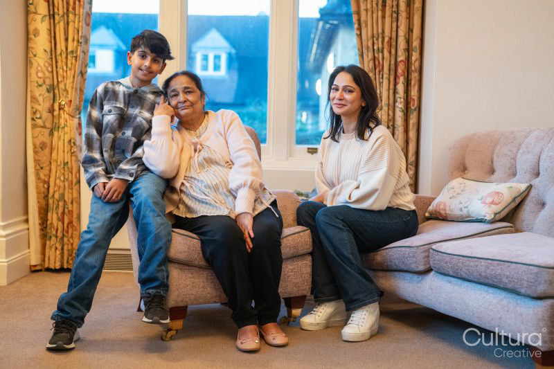 Mature woman and grandson visiting senior woman in nursing home