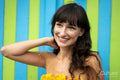 Smiling woman standing against striped wall