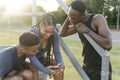 Group of athletes sitting on steps at stadium