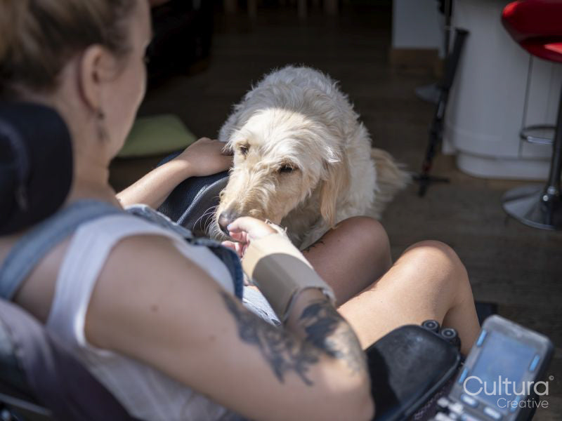 Woman in electric wheelchair with dog