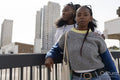 Portrait of young stylish female couple standing in city