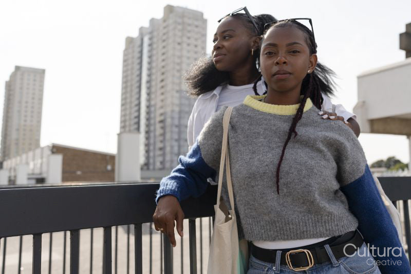 Portrait of young stylish female couple standing in city