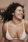 Studio shot of smiling young woman with curly hair