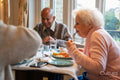 Group of seniors dining at cafeteria in nursing home
