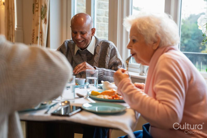Group of seniors dining at cafeteria in nursing home