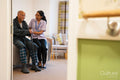 Nurse helping senior man in his room at nursing home