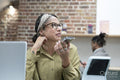 Woman talking on phone in office