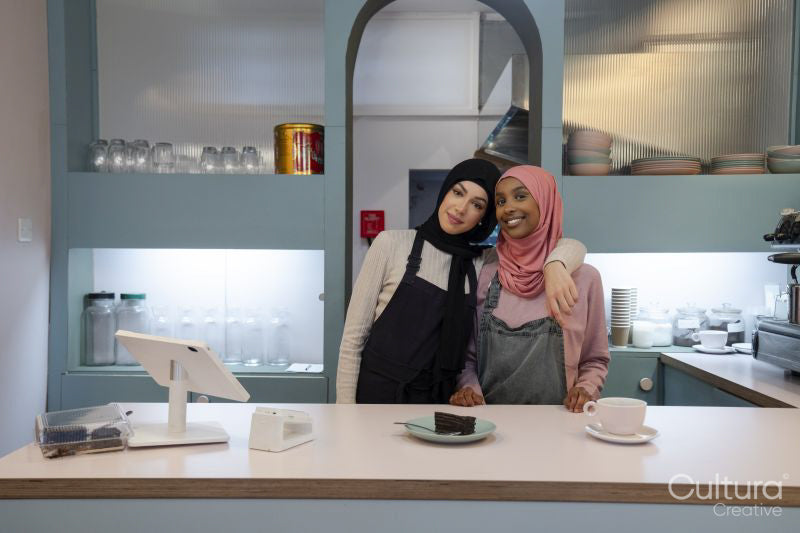 Portrait of smiling young women working in cafe