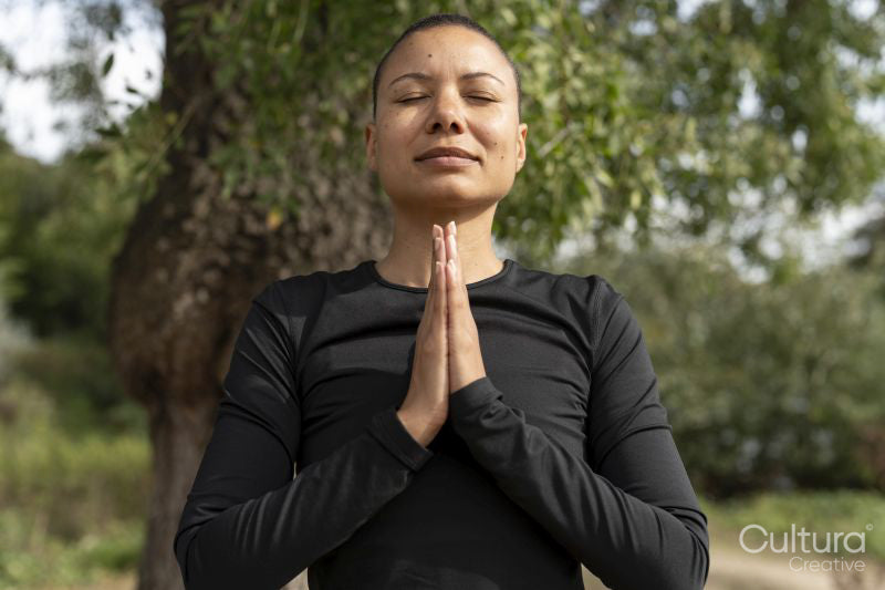 Woman meditating in park