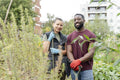 Portrait of smiling couple standing in urban garden