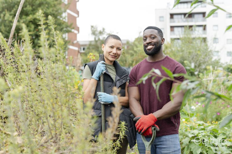 Portrait of smiling couple standing in urban garden