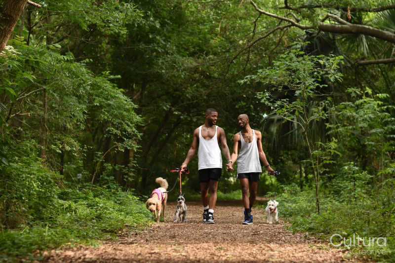 Louisiana, couple with dogs walking in park