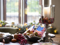 Thanksgiving decorations and American flag on table