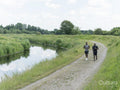 Two men jogging along river
