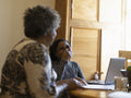Mother helping daughter with homework