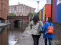 Rear view of couple walking on riverbank