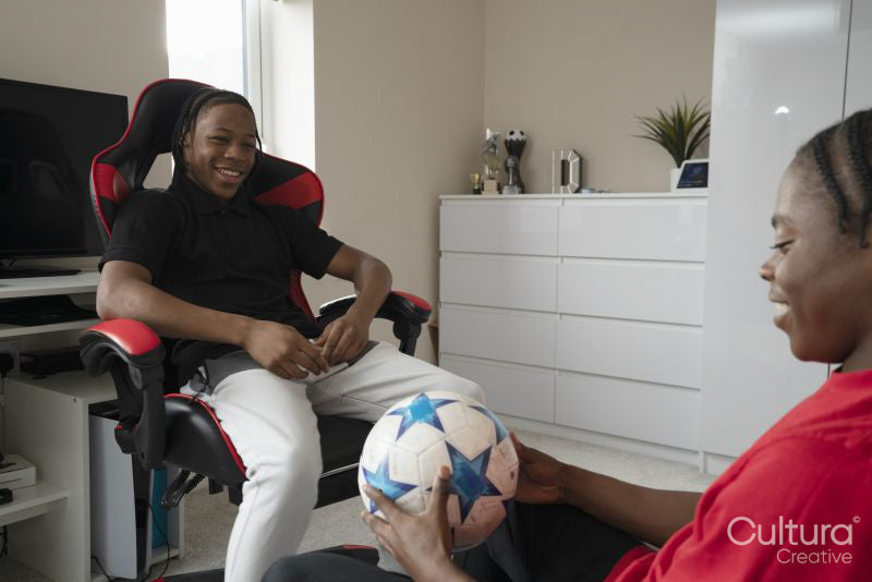 Cheerful teenage friends talking in bedroom