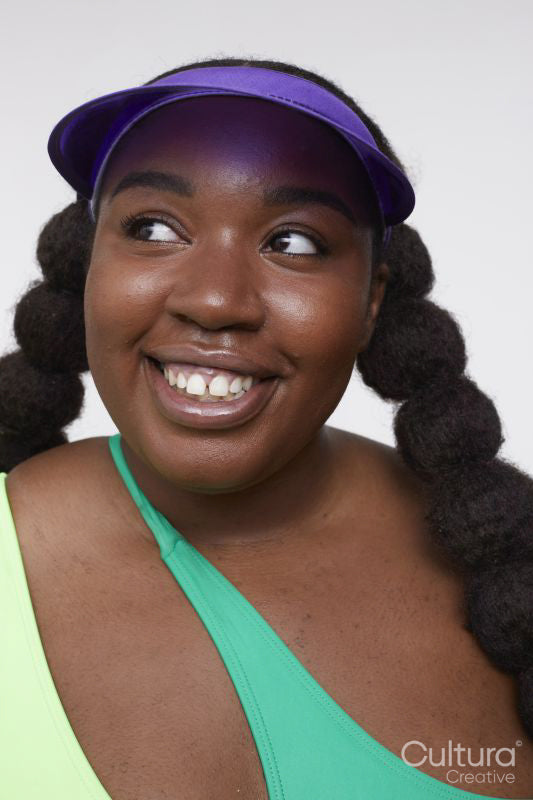 Studio shot of smiling young woman in vibrant clothing