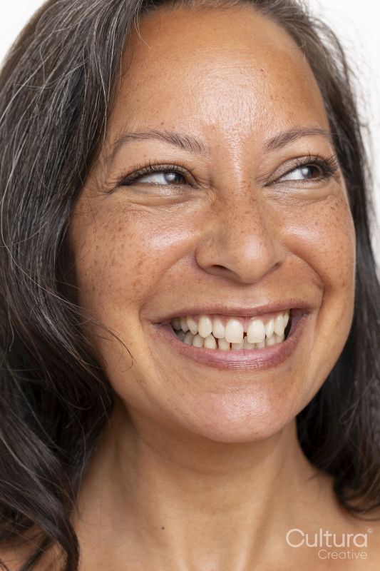 Close-up of smiling woman looking on side