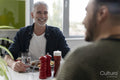 Male couple eating breakfast at home