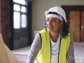Portrait of woman in hardhat and reflective vest