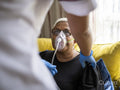 Nurse helping patient use oxygen mask