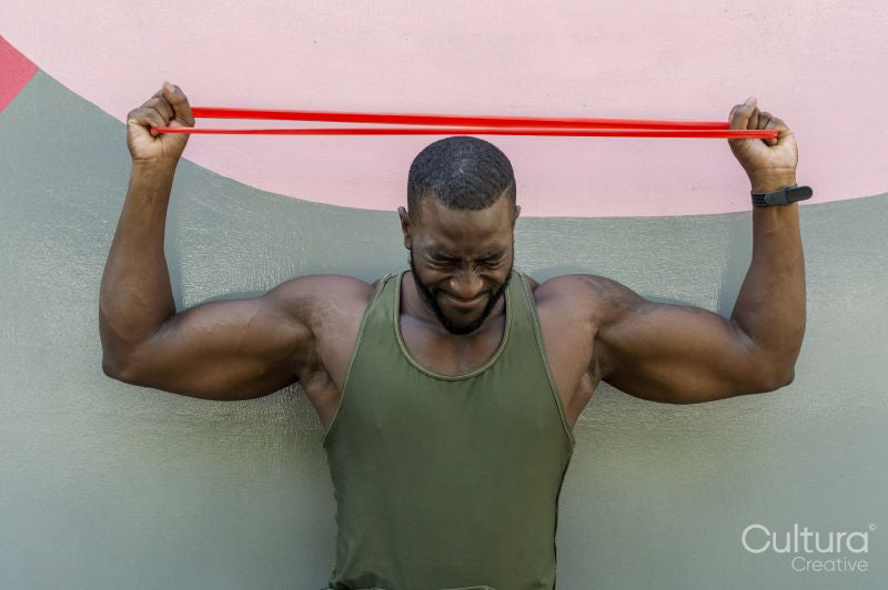 Mid adult man holding resistance band