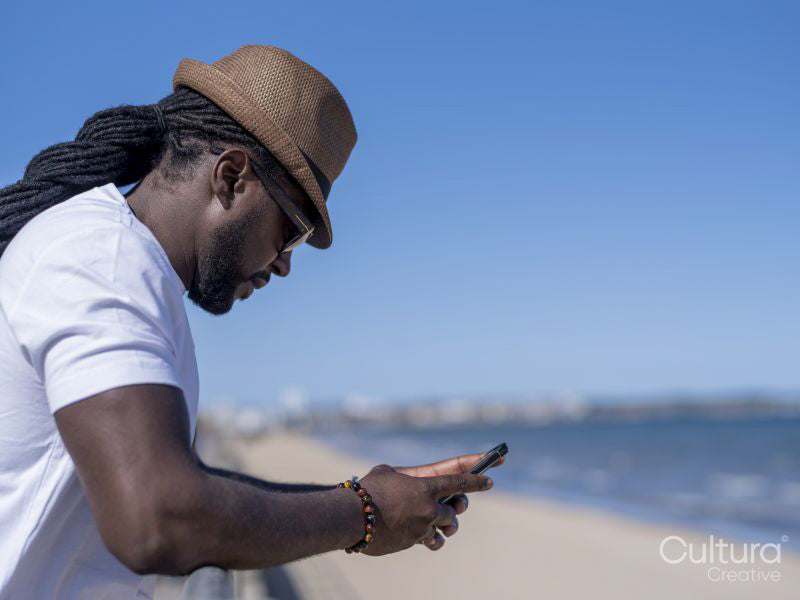 Man using phone on beach