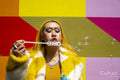Young woman blowing bubbles outdoors