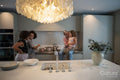 Smiling women with two daughters cooking at home