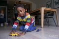 Boy playing on living room floor