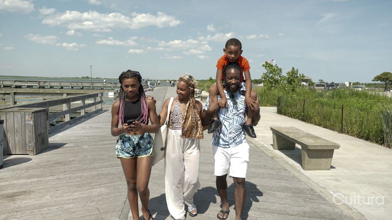 Smiling family walking on pier