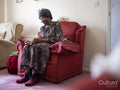 Elderly woman sitting in armchair