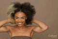 Studio portrait of smiling woman with two toned hair