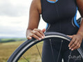 Woman checking bicycle tire