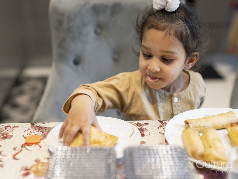 Boy putting food on plate