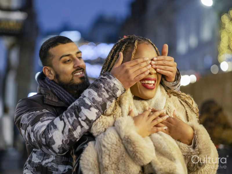 Boyfriend covering girlfriends eyes for surprise