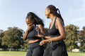 Young female friends walking in park after exercising