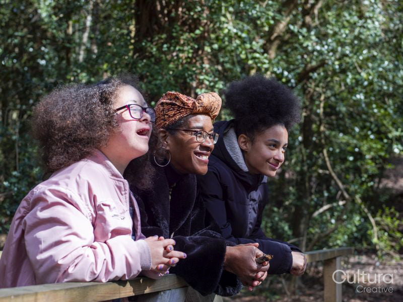Mother with two daughters on footbridge