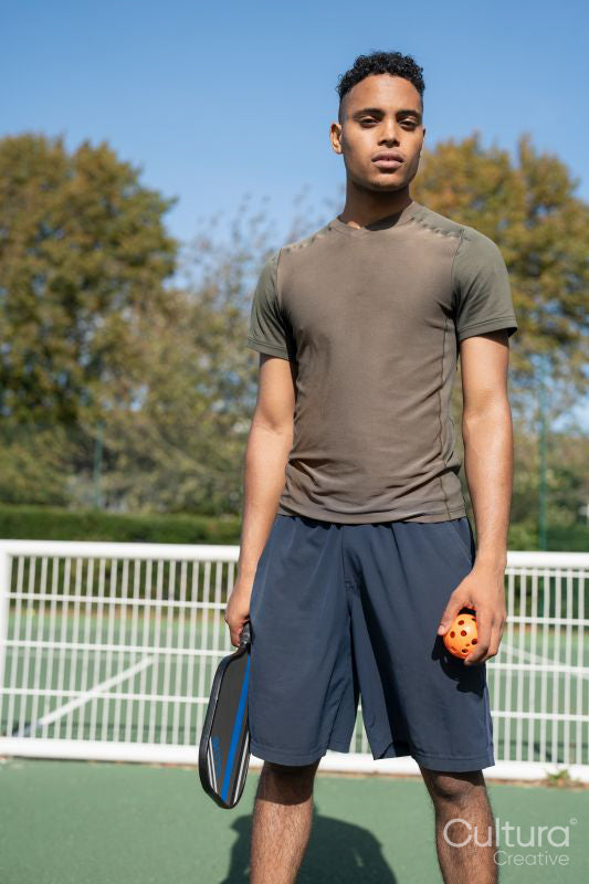 Portrait of man standing in pickleball court