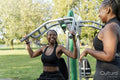 Young female friends working out in outdoor gym