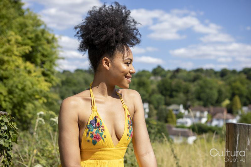 Portrait of young woman wearing yellow dress