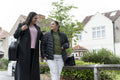 Mother walking with down syndrome daughter in residential district