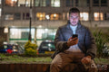 Young man using smart phone outdoors