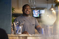 Smiling bartender at bar