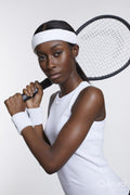 Studio portrait of athletic woman with tennis racket