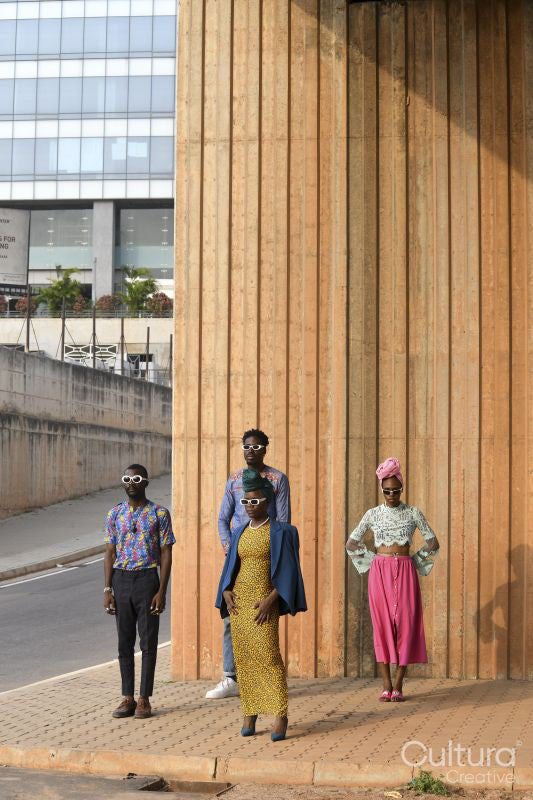 Fashion shot of four people standing in urban street