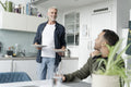 Male couple eating breakfast at home