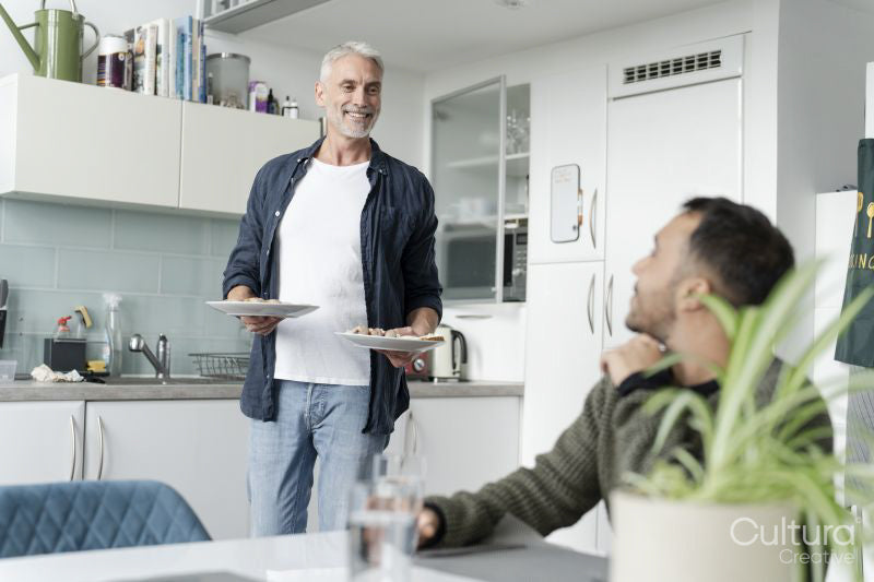 Male couple eating breakfast at home
